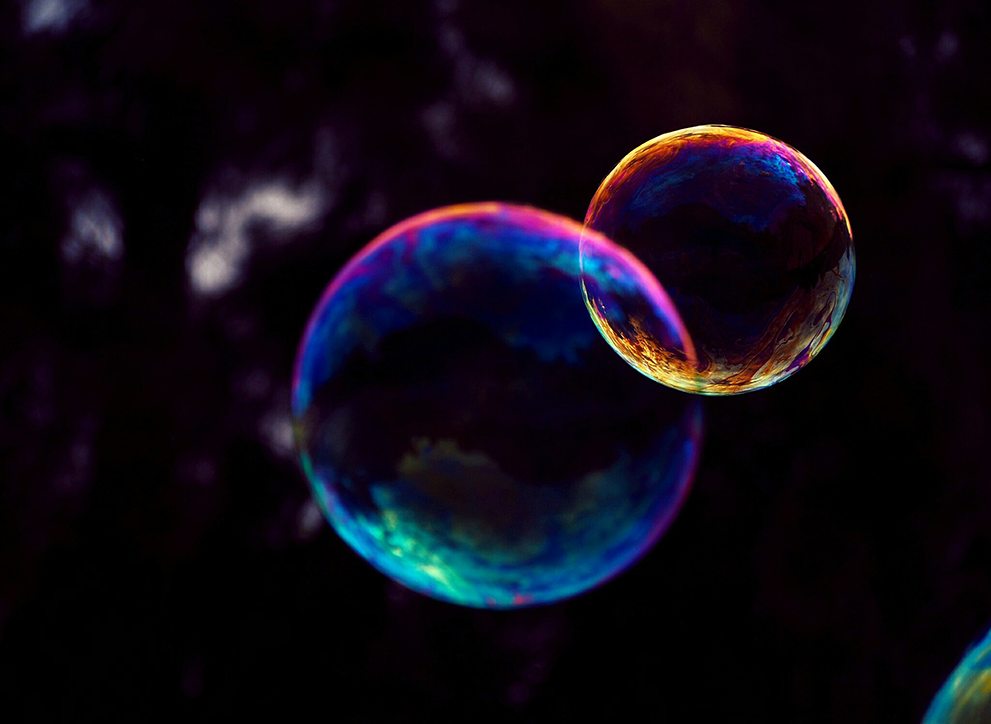 Two bubbles overlapping on a black background.