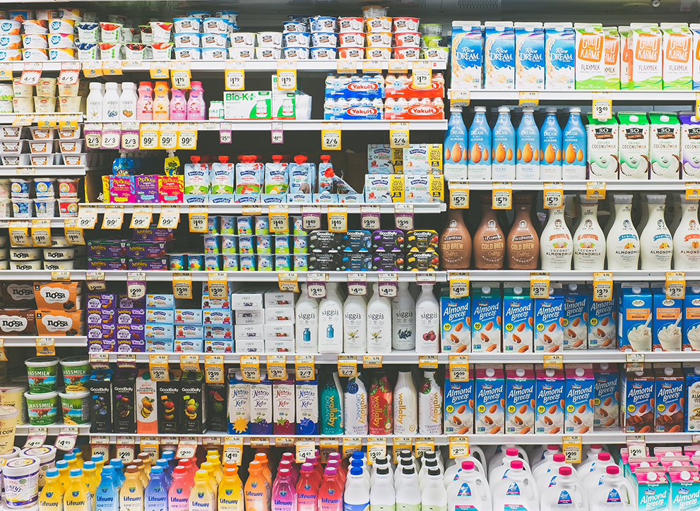 Dairy products lined up on refrigerator shelves in a farmers market in the United States.