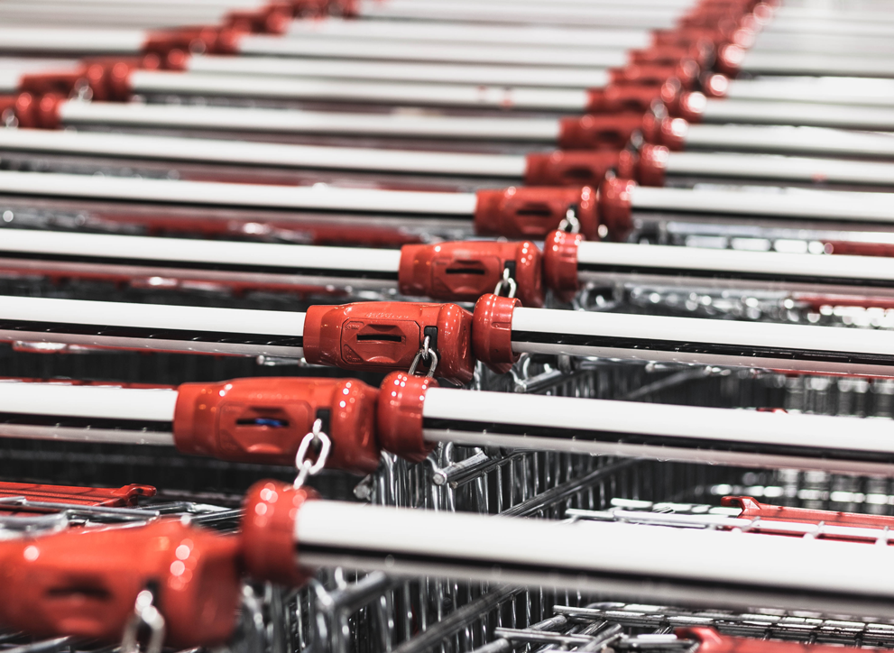 Close up of shopping trolleys linked together.