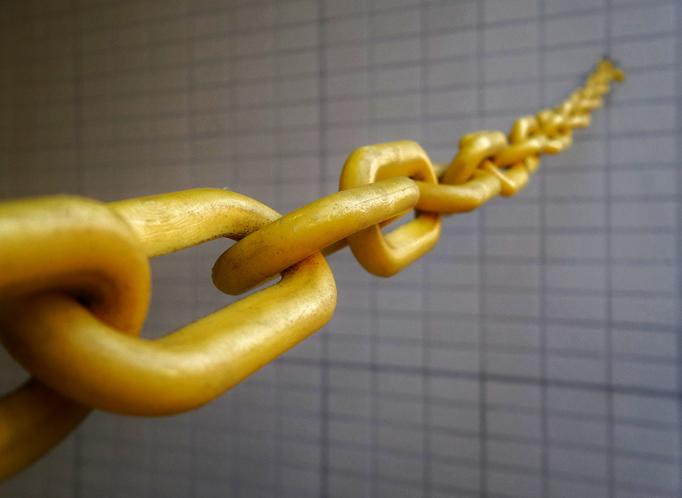Photo of yellow chain links by Possessed Photography on Unsplash.