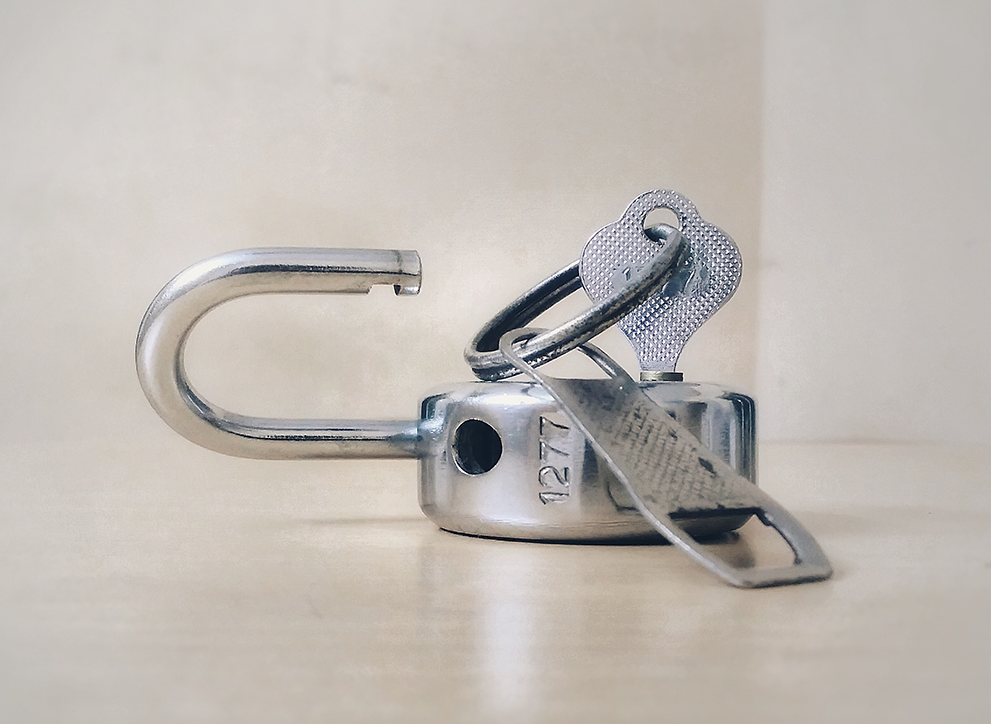 Open lock and key. Photo by Basil James on Unsplash.