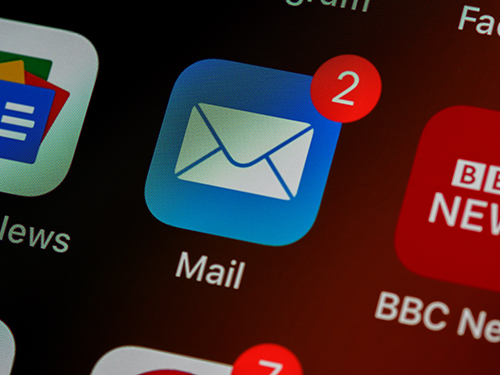 Photo of an email app on a mobile device screen, showing 2 unread notifications. Photo by Brett Jordan on Unsplash.