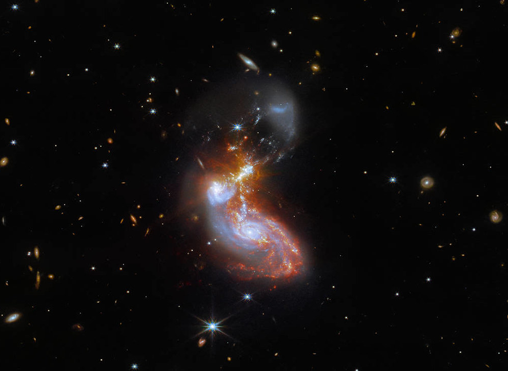 Image from the James Webb telescope showing two galaxies in the process of merging, twisting each other out of shape.